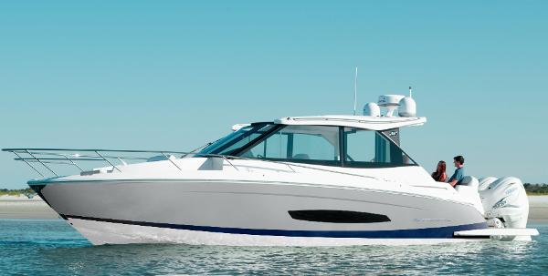 Regal 36 XO 2026 Regal 36 XO boat cruising on calm waters under clear blue sky.