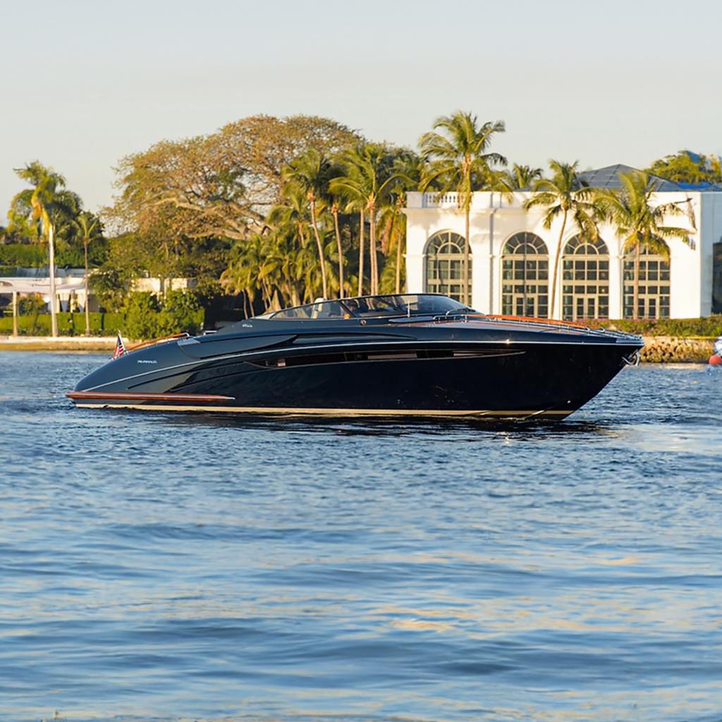 Riva Rivarama Super 44 2014 Riva Rivarama Super 44 yacht cruising near palm trees and luxury villa.