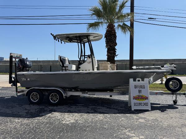 Pathfinder 2300 HPS 2025 Pathfinder 2300 HPS boat on trailer, displayed outdoors with palm tree background.