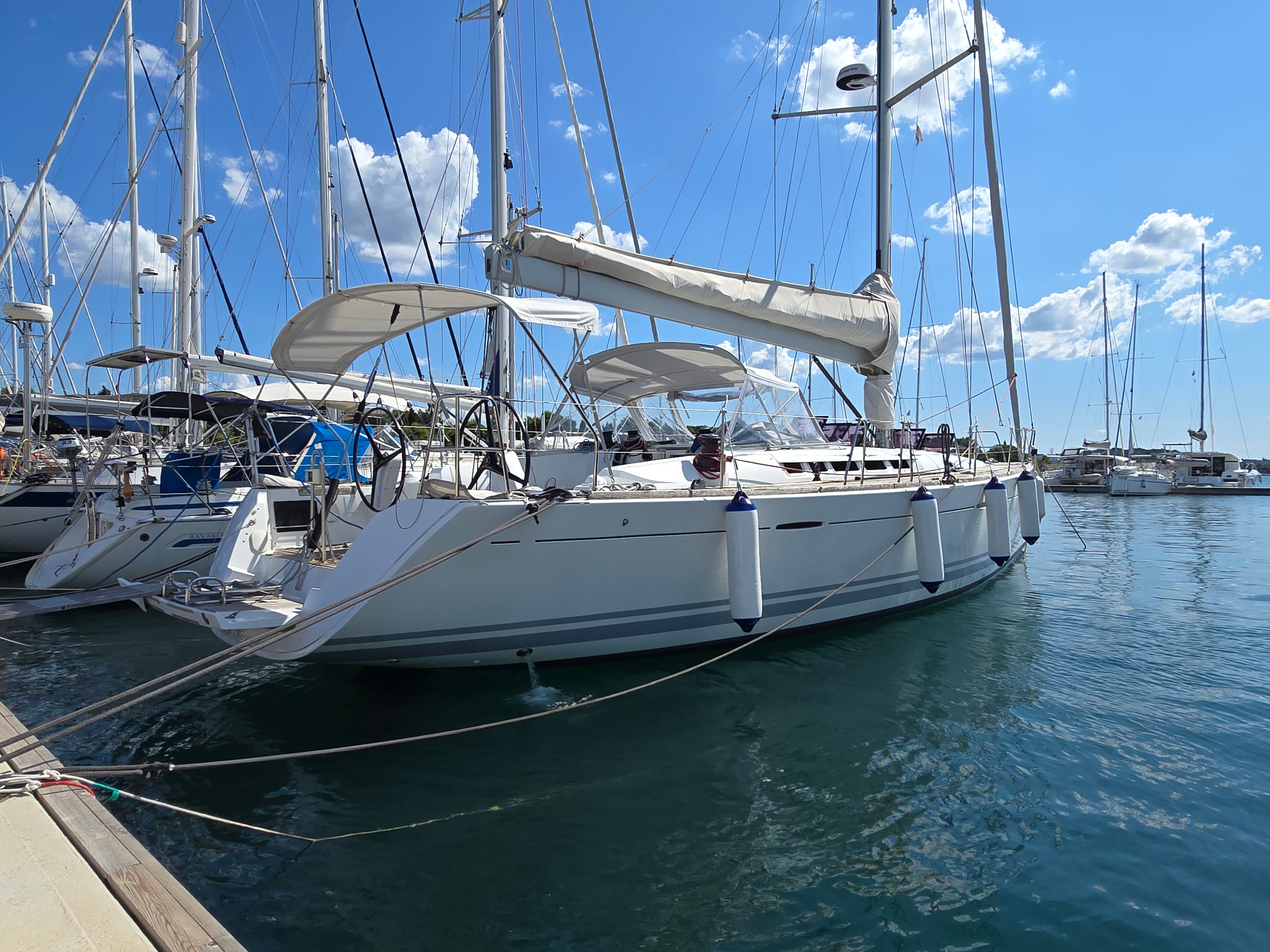 Beneteau First 50 2009 Beneteau First 50 sailboat docked in marina under clear blue sky.