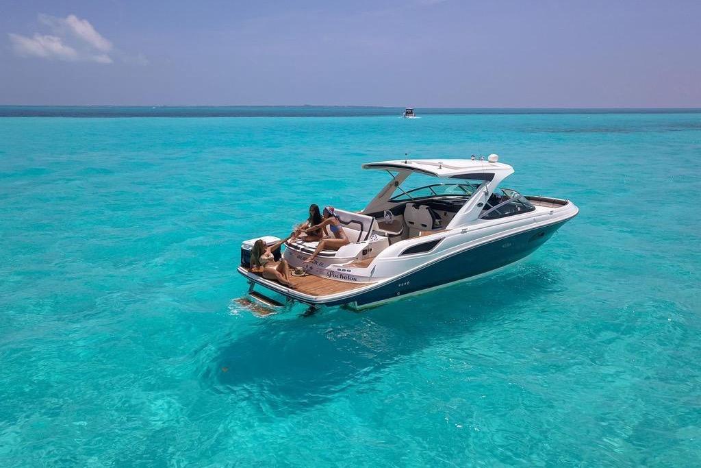 Sea Ray SLX 350 2017 Sea Ray SLX 350 boat on clear turquoise water, people relaxing onboard.