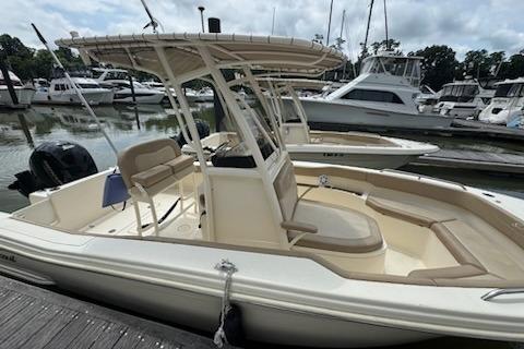 Scout 215 XSF 2023 Scout 215 XSF boat docked at marina, featuring sleek design and spacious seating.