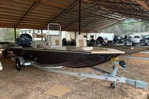 G3 Bay 20 GX 2024 G3 Bay 20 GX boat under a metal canopy, on a trailer.