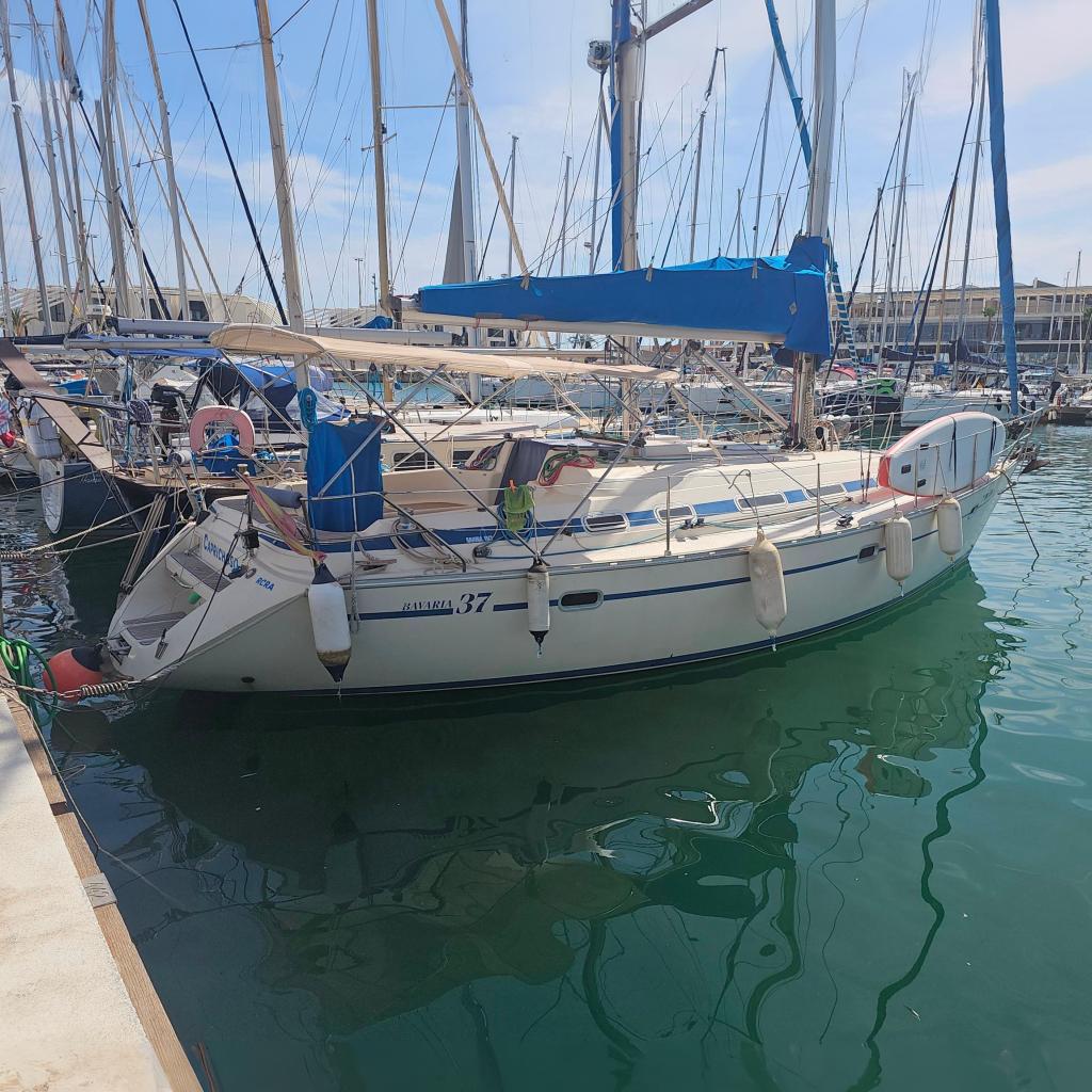 Bavaria 37 Sailboat Bavaria 37, 1994 model, docked in a marina with clear water reflections.