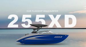 Yamaha Boats 255XD 2025 Yamaha Boats 255XD flagship wakesurfer on serene water background.