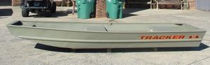 Tracker Grizzly 1436 Utility 2026 Tracker Grizzly® 1436 Utility boat in a driveway, showcasing its sleek design.