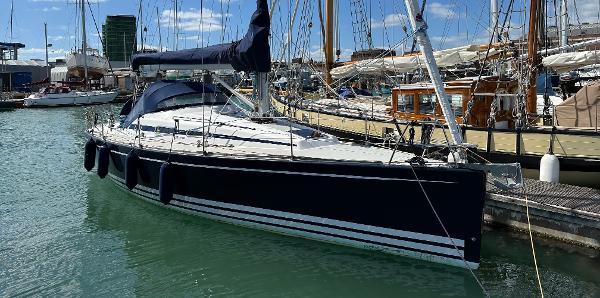 Arcona 340 2009 Arcona 340 sailboat docked in a marina, featuring sleek design and blue hull.