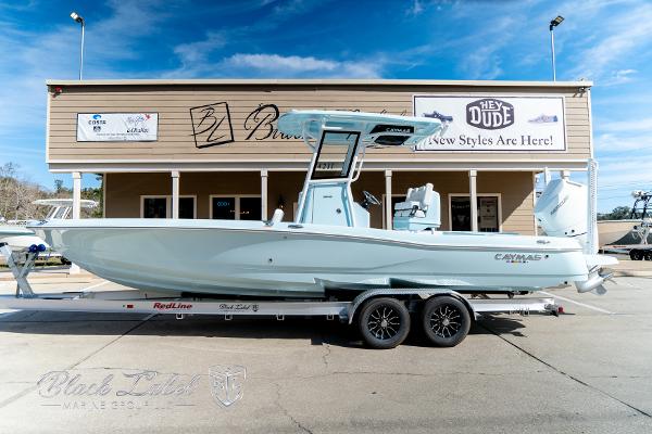 Caymas 28 HB 2025 Caymas 28 HB boat on trailer, parked outside a building under a clear blue sky.