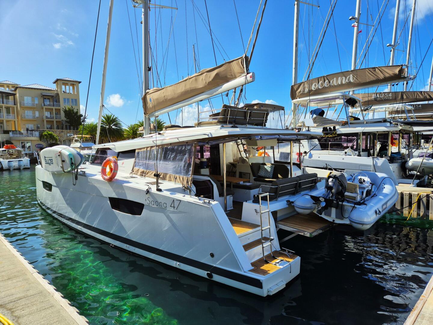 Fountaine Pajot Saona 47 2019 Fountaine Pajot Saona 47 catamaran docked in a sunny marina.