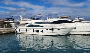 Fairline Squadron 55 2009 Fairline Squadron 55 yacht docked in a marina under a partly cloudy sky.
