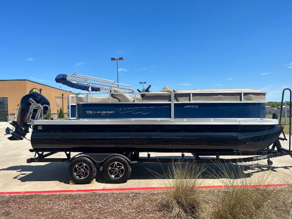 Ranger Reata 200F 2024 Ranger Reata 200F pontoon boat on a trailer in a parking lot.