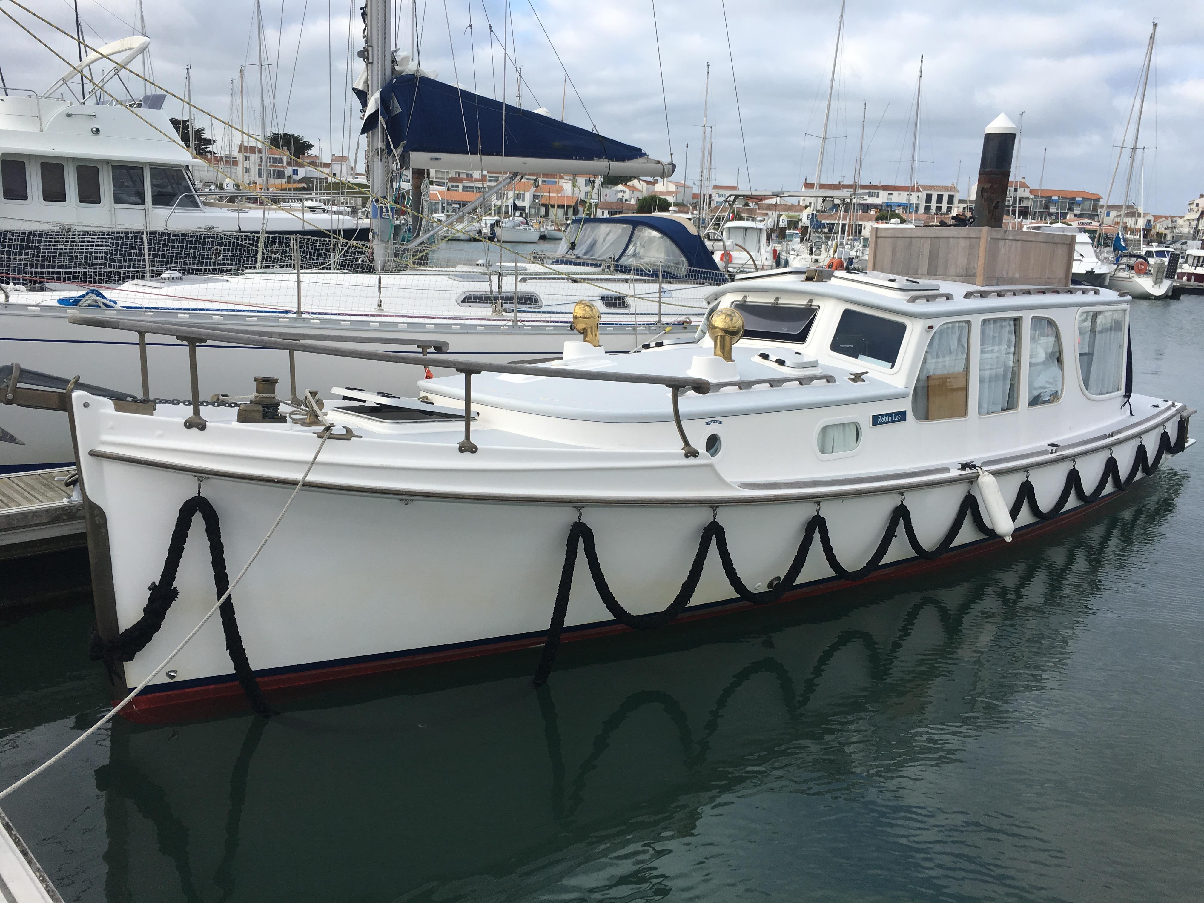 Custom Logan 33 Custom Logan 33 boat, 2007 model, docked in a marina with other vessels.