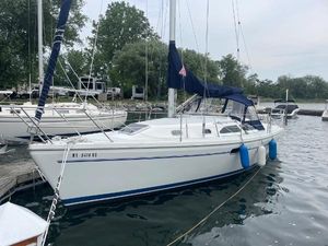 Catalina 310 2000 Catalina 310 sailboat docked in a marina with blue fenders.