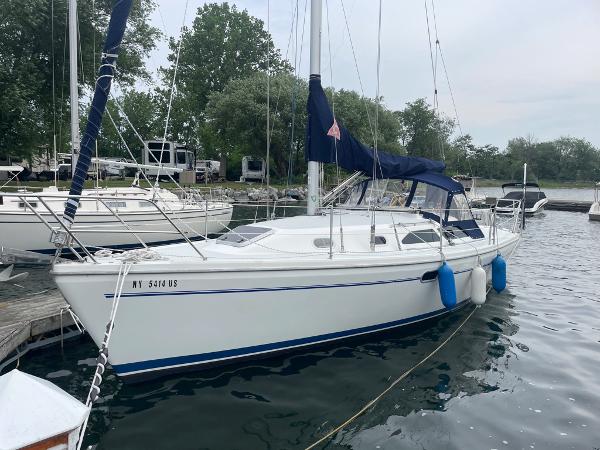 Catalina 310 2000 Catalina 310 sailboat docked in a marina with blue fenders.