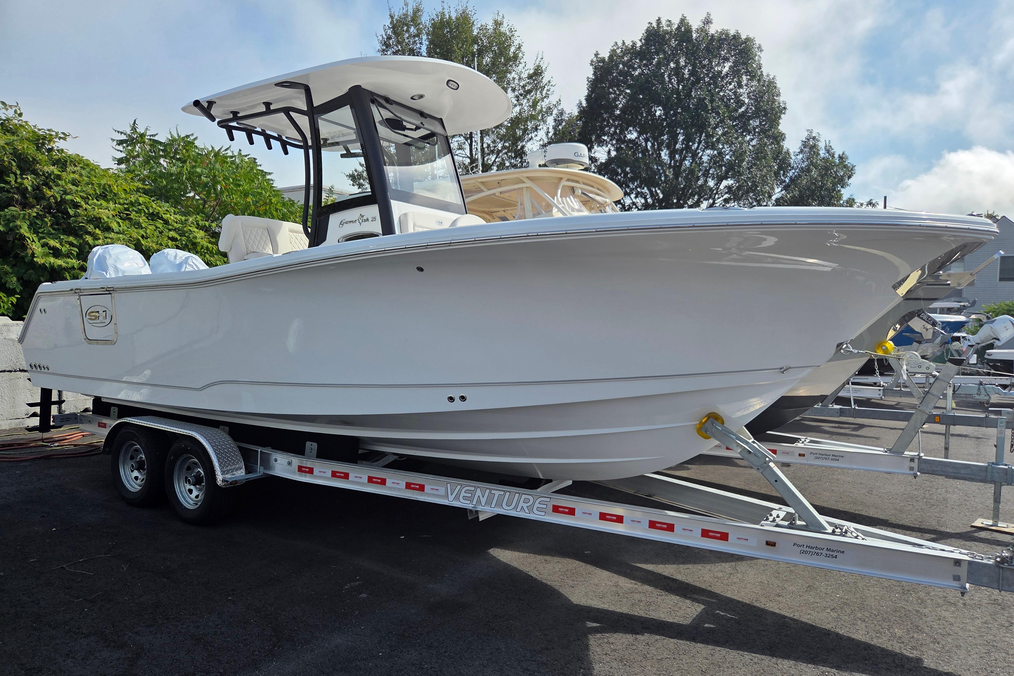 Sea Hunt Gamefish 25 2026 Sea Hunt Gamefish 25 boat on trailer, parked outdoors.