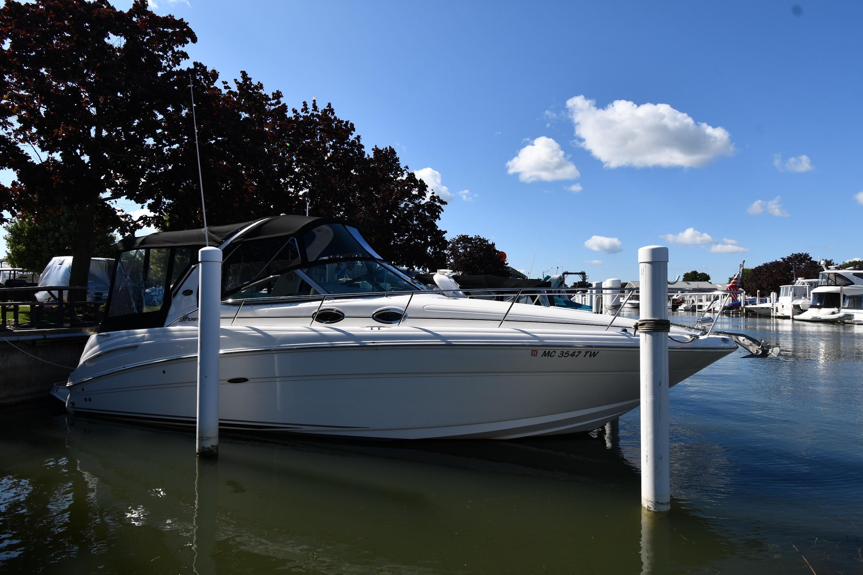 Sea Ray 300 Sundancer 2005 Sea Ray 300 Sundancer docked at marina under clear blue sky.