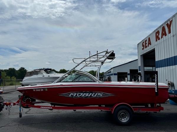 Moomba Mobius LSV 2007 Moomba Mobius LSV boat in red on a trailer outside a Sea Ray dealership.