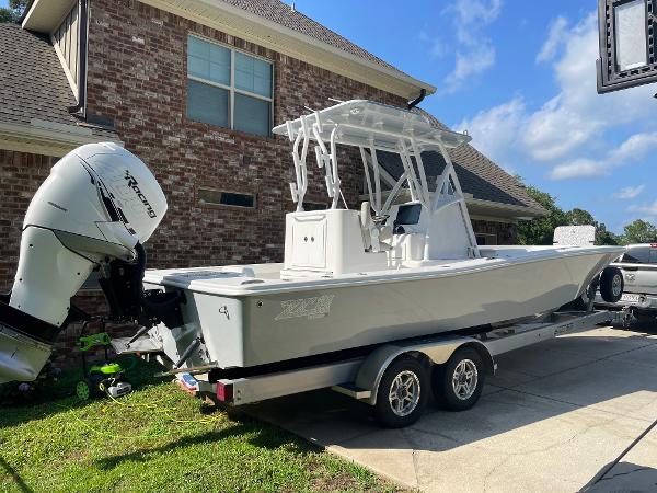 ZCB 26 Freemason 2022 ZCB 26 Freemason boat on trailer in driveway near brick house.