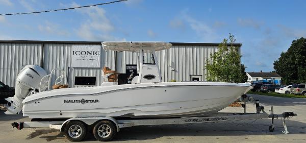NauticStar 251 Hybrid 2025 NauticStar 251 Hybrid boat on trailer outside dealership.