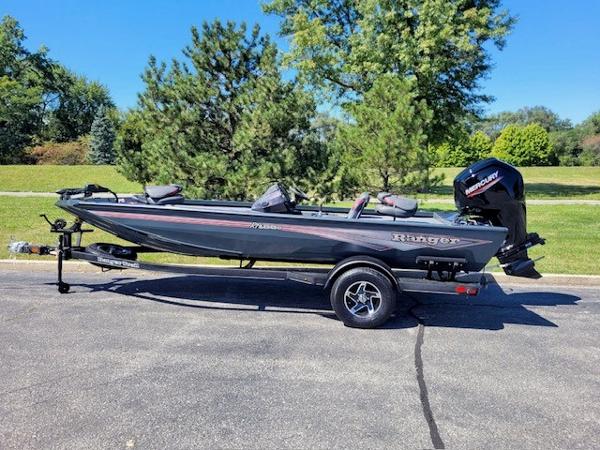 Ranger RT188C 2024 Ranger RT188C boat on trailer, parked outdoors with trees in background.