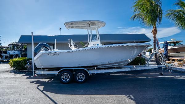 Tidewater 220 LXF 2025 Tidewater 220 LXF boat on trailer, parked outdoors under clear blue sky.