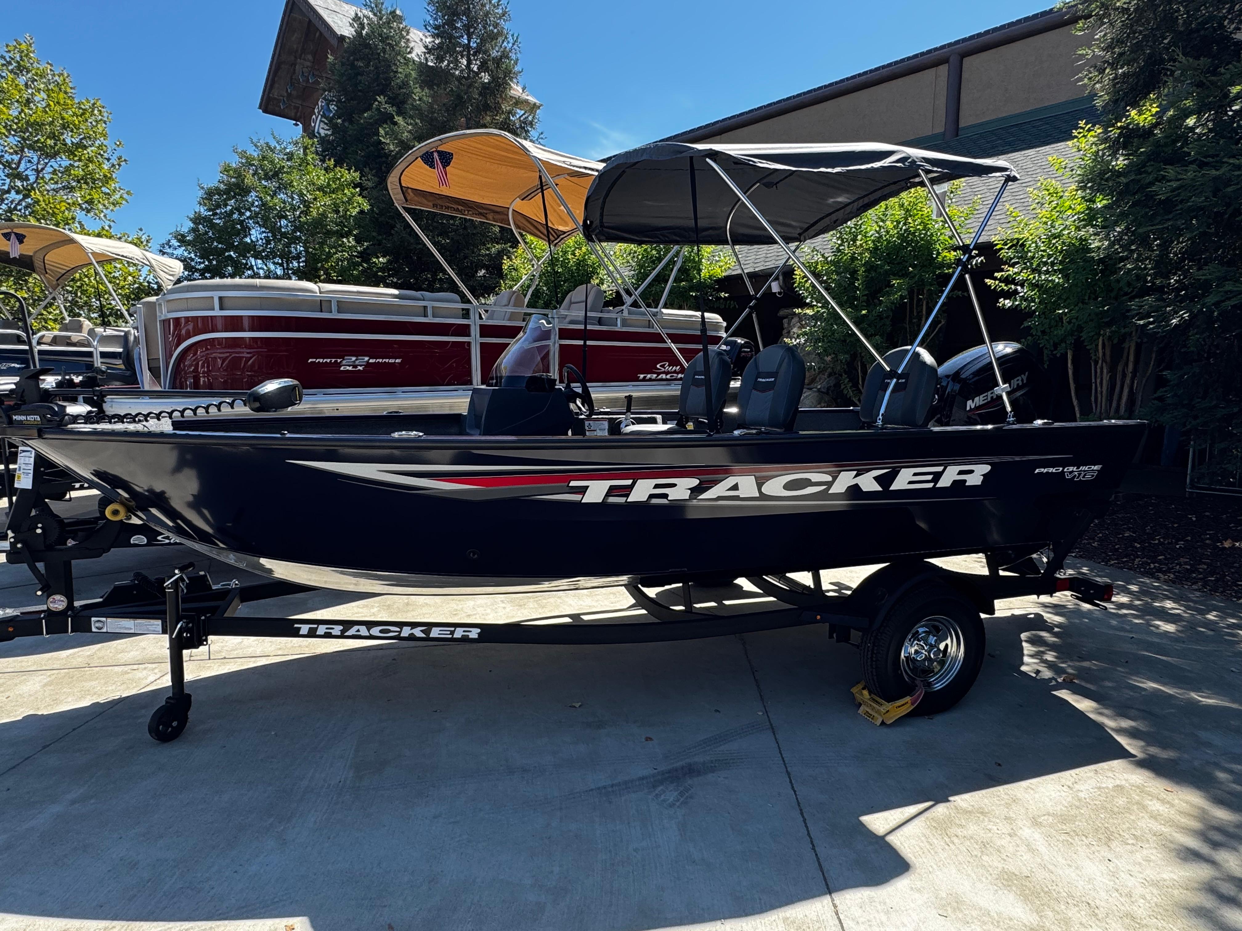 Tracker Pro Guide V-16 SC 2025 Tracker Pro Guide V-16 SC boat on trailer, parked outdoors.