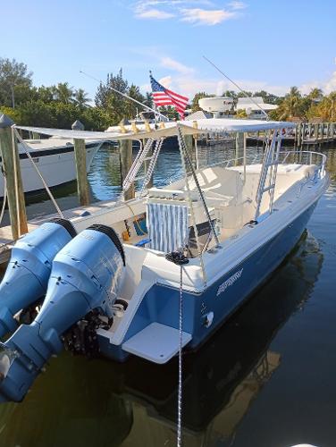 Intrepid 356 Center Console Cuddy 1998 Intrepid 356 Center Console Cuddy boat docked with dual engines and American flag.