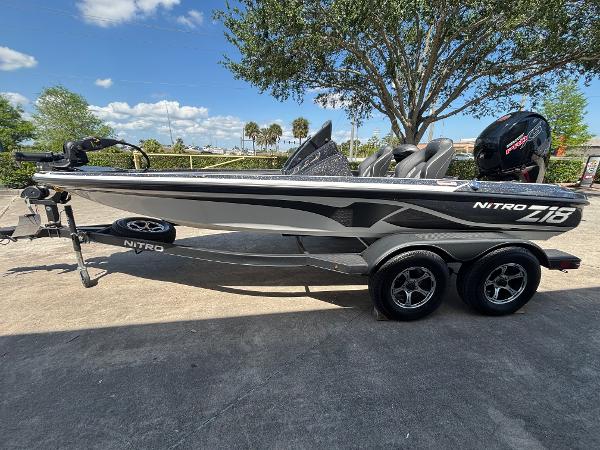 Nitro Z18 2024 Nitro Z18 boat on trailer, parked outdoors under a clear blue sky.