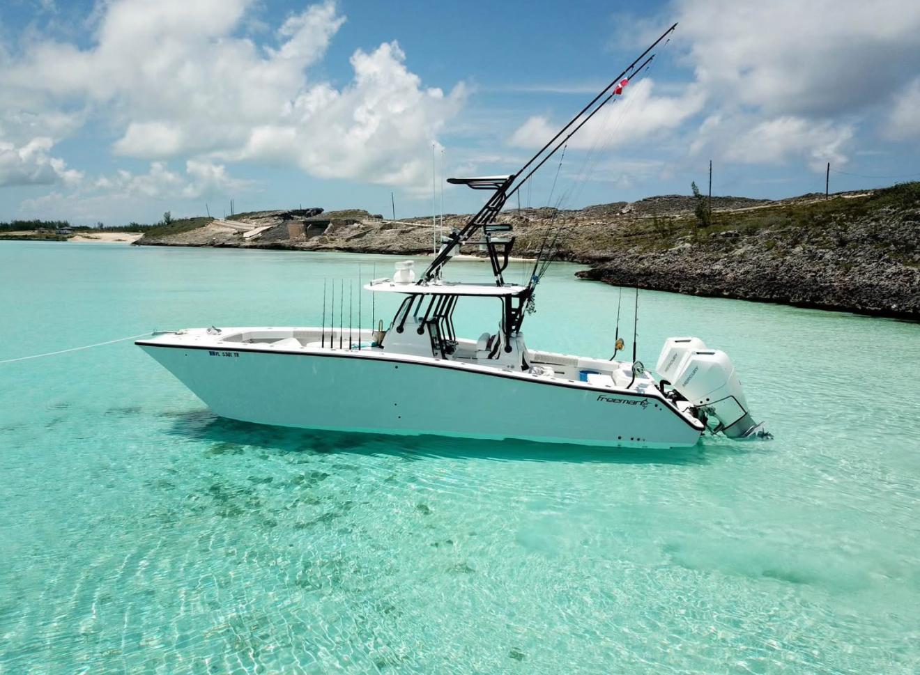 Freeman 34 2023 Freeman 34 boat in clear turquoise water, under a partly cloudy sky.