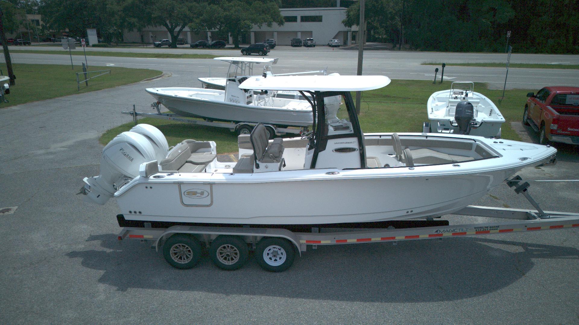 Sea Hunt Ultra 265 SE 2026 Sea Hunt Ultra 265 SE boat on trailer, parked outdoors.
