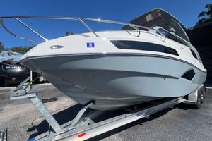 NX Boats 290 Exclusive 2024 NX Boats 290 Exclusive on trailer, sleek design, sunny day.
