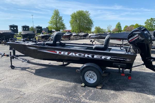 Tracker Panfish 17 2025 Tracker Panfish 17 boat with Mercury engine on trailer, parked outdoors.
