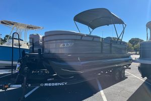 Regency 230 DL3 2024 Regency 230 DL3 pontoon boat on trailer under clear blue sky.
