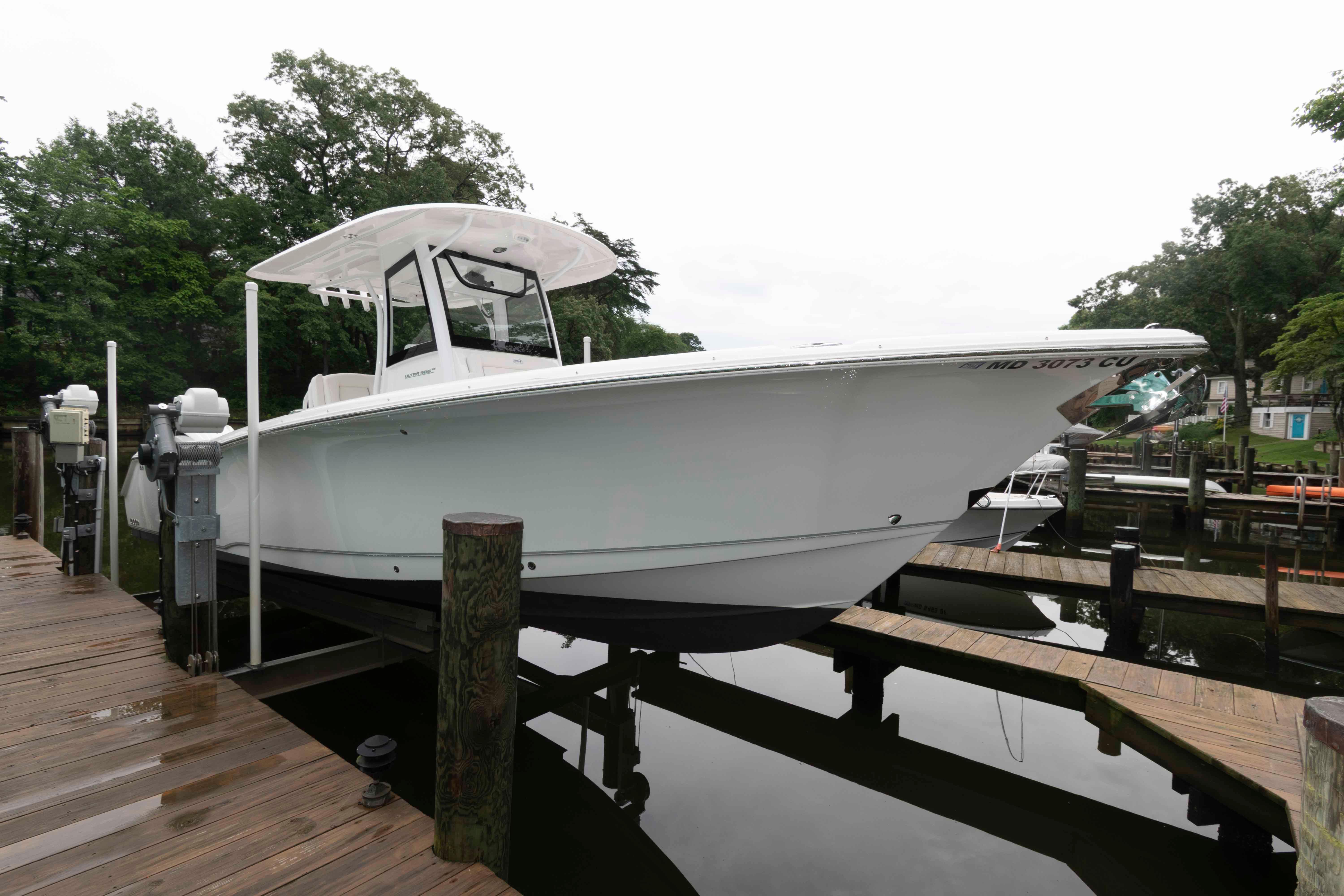 Sea Hunt Ultra 305 SE 2024 Sea Hunt Ultra 305 SE boat docked on a wooden pier.