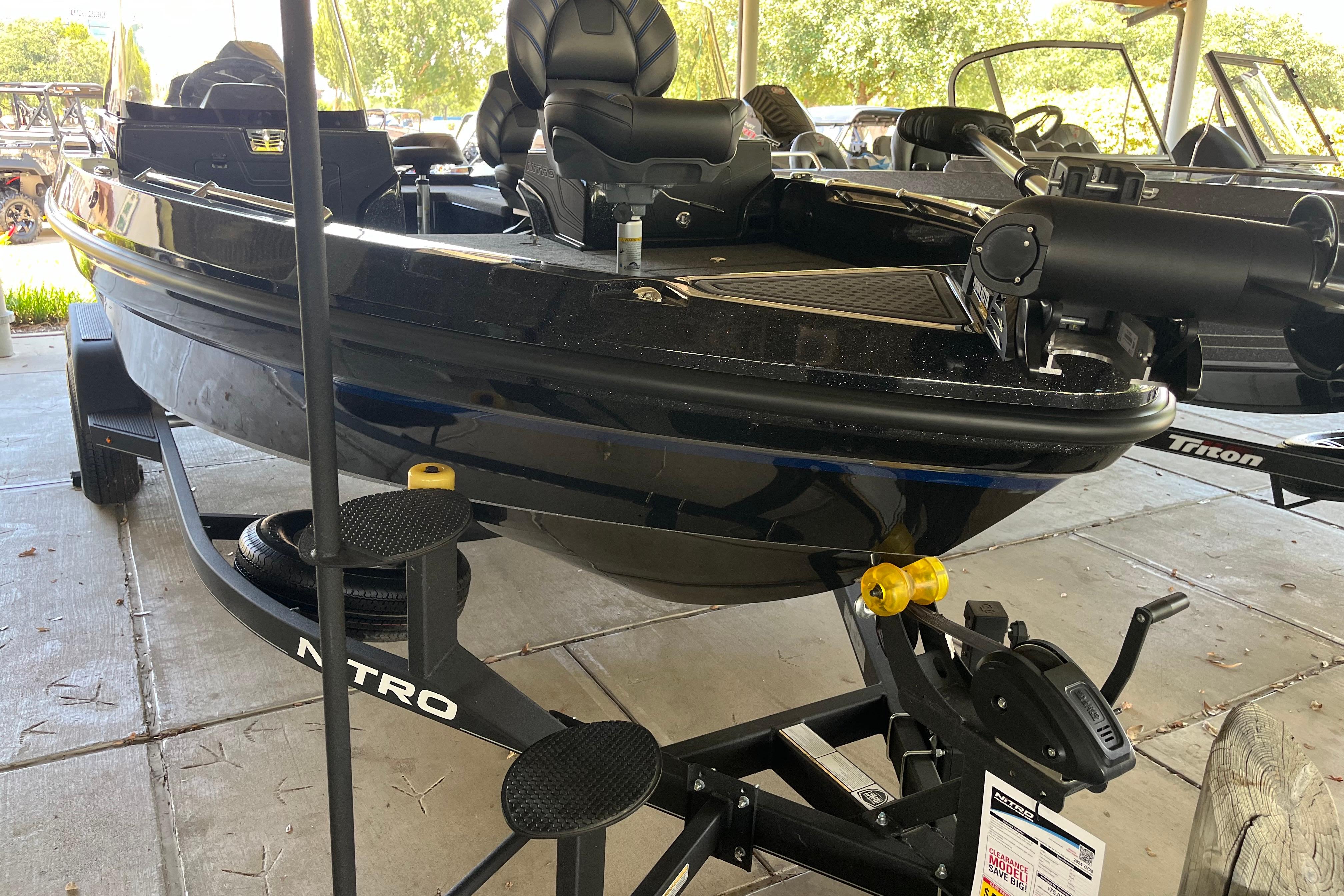 Nitro ZV20 2024 Nitro ZV20 boat on trailer, black exterior, parked under shelter.