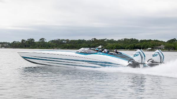 MTI 440X 2024 MTI 440X speedboat cruising on a calm lake with twin engines.