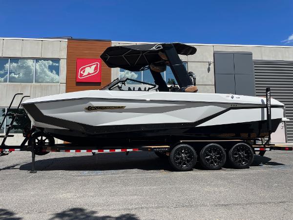 Nautique Super Air Nautique G25 2025 Nautique Super Air Nautique G25 boat on trailer, parked outside a building.