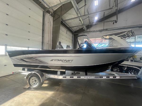 Starcraft Fishmaster 196 2023 Starcraft Fishmaster 196 boat on trailer in indoor showroom.