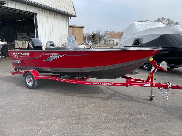 Crestliner 1650 Fish Hawk 2023 Crestliner 1650 Fish Hawk boat on a red trailer outside a warehouse.