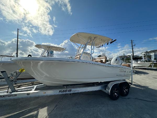 Pioneer 202 Sportfish 2025 Pioneer 202 Sportfish boat on trailer under blue sky.