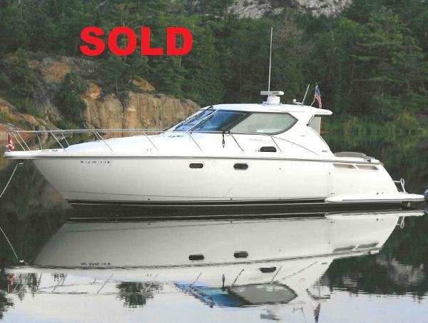 Tiara Yachts 4300 Sovran 2007 Tiara Yachts 4300 Sovran, sold, docked on calm water with forest backdrop.