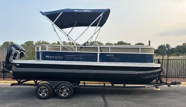 Ranger Reata 200C 2024 Ranger Reata 200C pontoon boat with canopy on trailer.