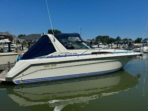 Sea Ray 370 Sundancer 1993 Sea Ray 370 Sundancer boat docked in a marina under clear blue skies.