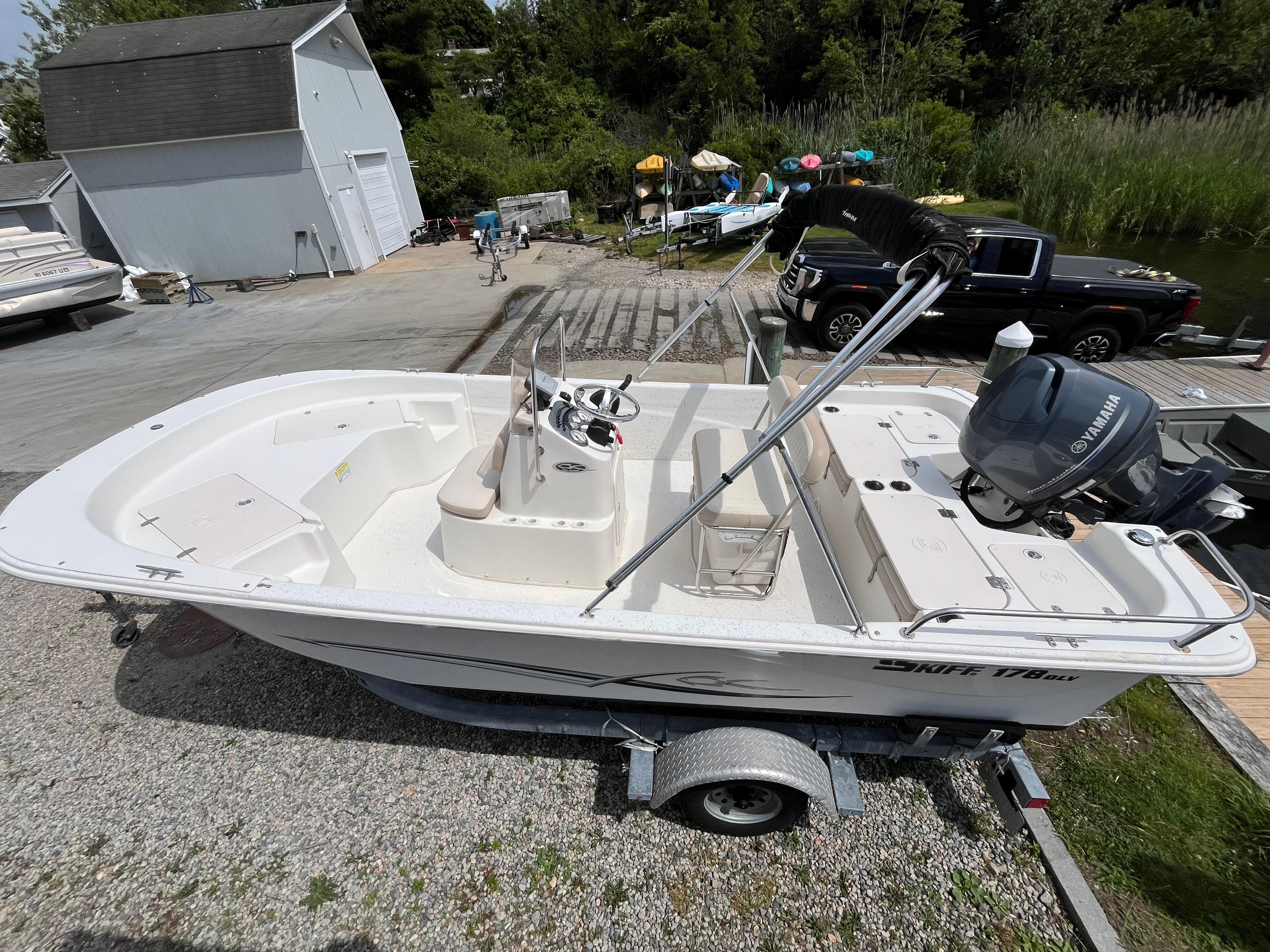 Carolina Skiff 178 DLV 2013 Carolina Skiff 178 DLV boat on trailer, Yamaha motor, outdoor setting.