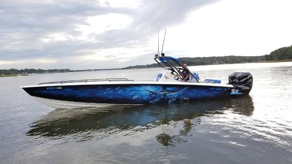 Concept 36' CC 2014 Concept 36' CC boat with custom marine-themed hull design on calm water.