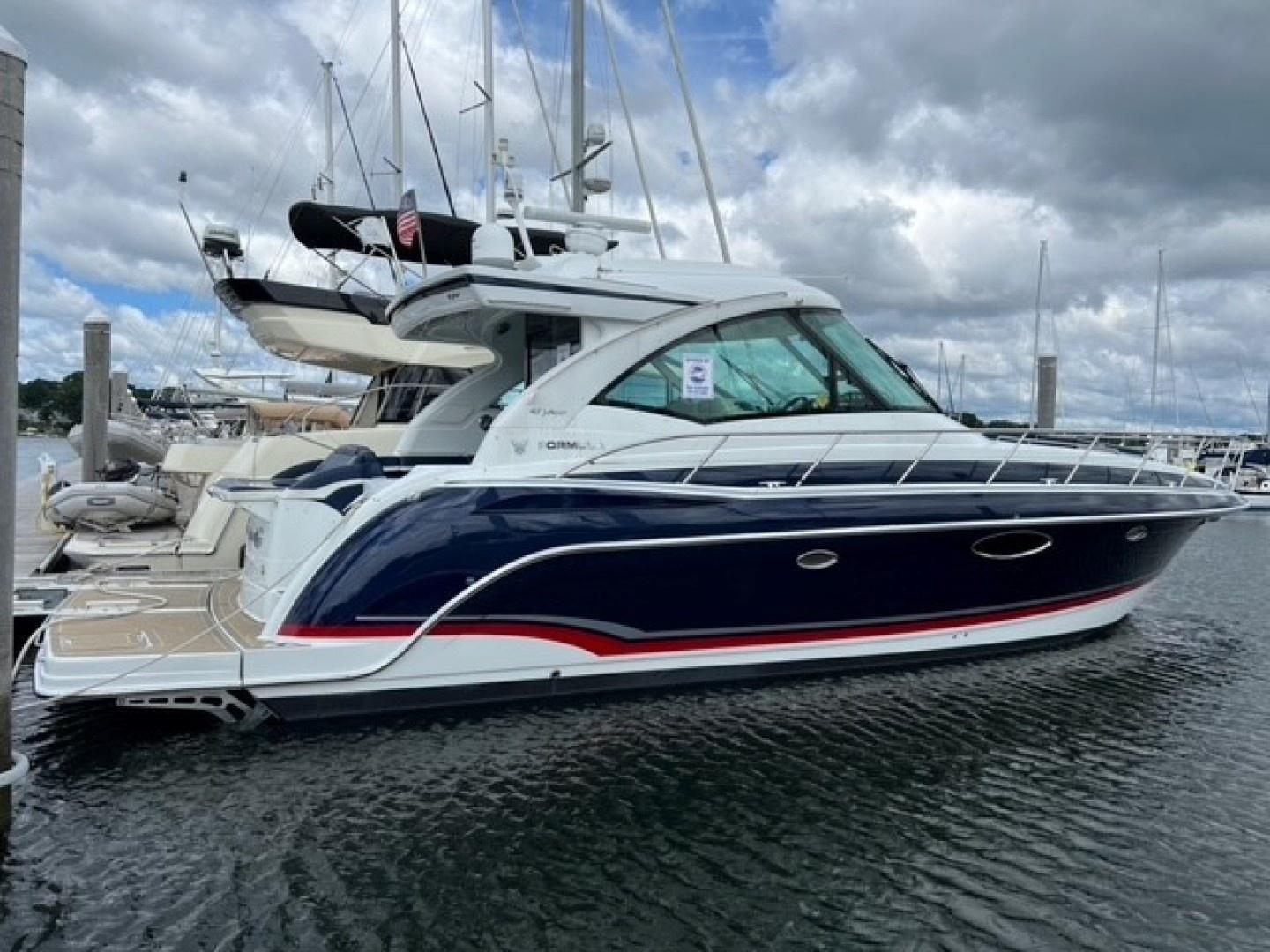 Formula 45 Yacht 2015 Formula 45 Yacht docked at marina under cloudy sky.