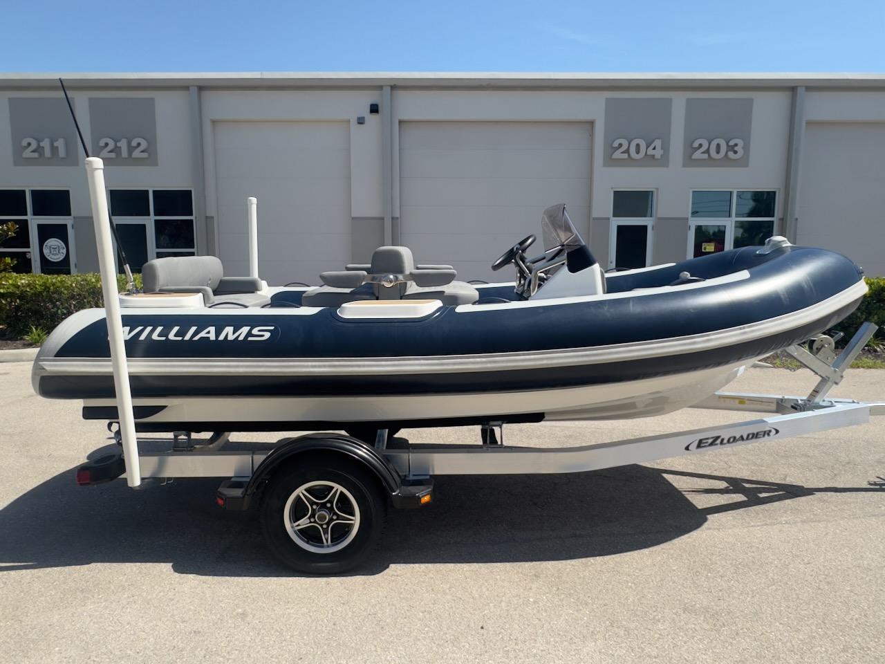 Williams Jet Tenders 445 Diesel Jet 2024 Williams Jet Tenders 445 Diesel Jet boat on trailer, parked outside industrial building.