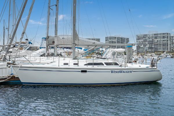 Catalina 320 Catalina 320 sailboat, 2000 model, docked in marina with cityscape background.