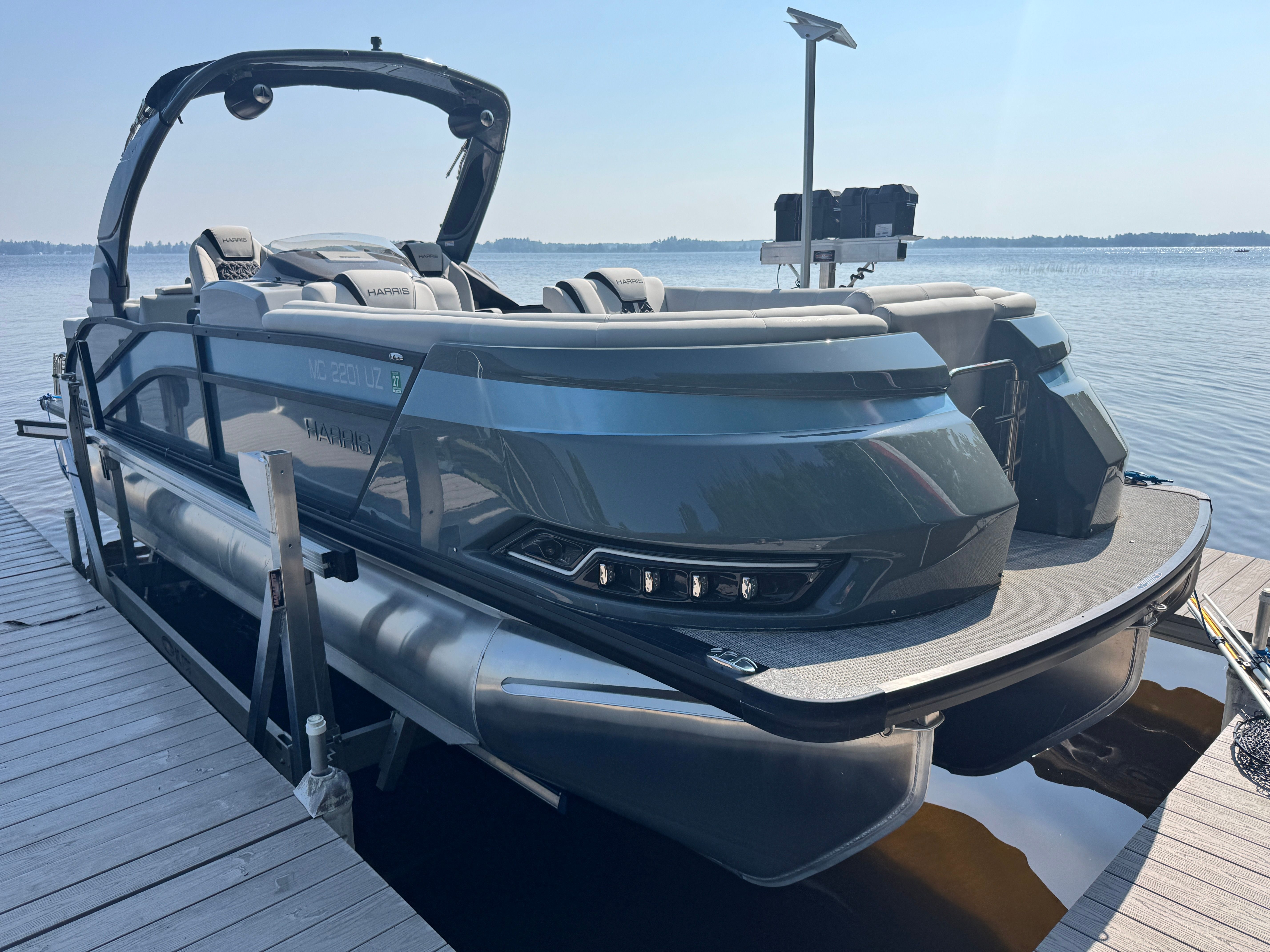 Harris 250 Grand Mariner 2024 Harris 250 Grand Mariner pontoon boat docked on a sunny day.