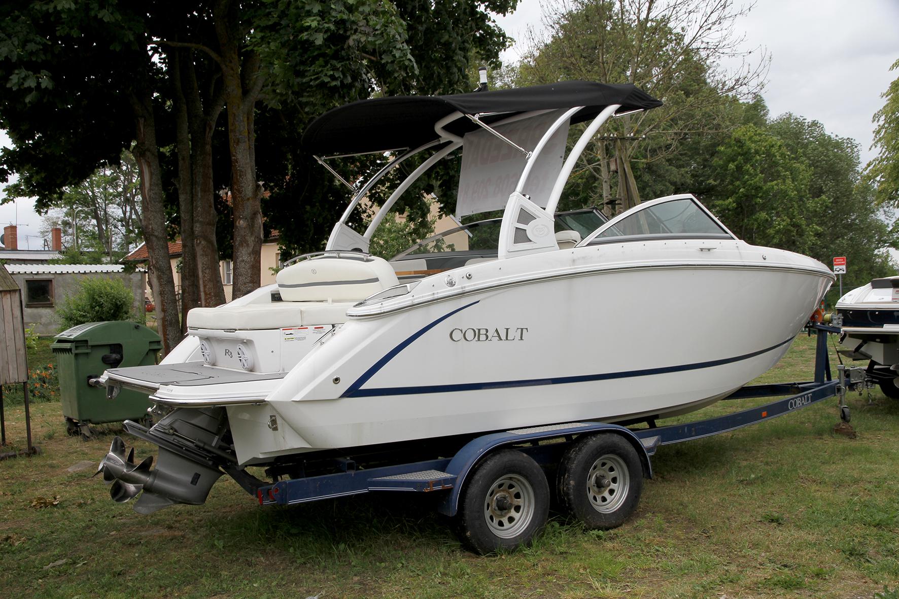 Cobalt R3 2018 Cobalt R3 boat on trailer, parked outdoors near trees.